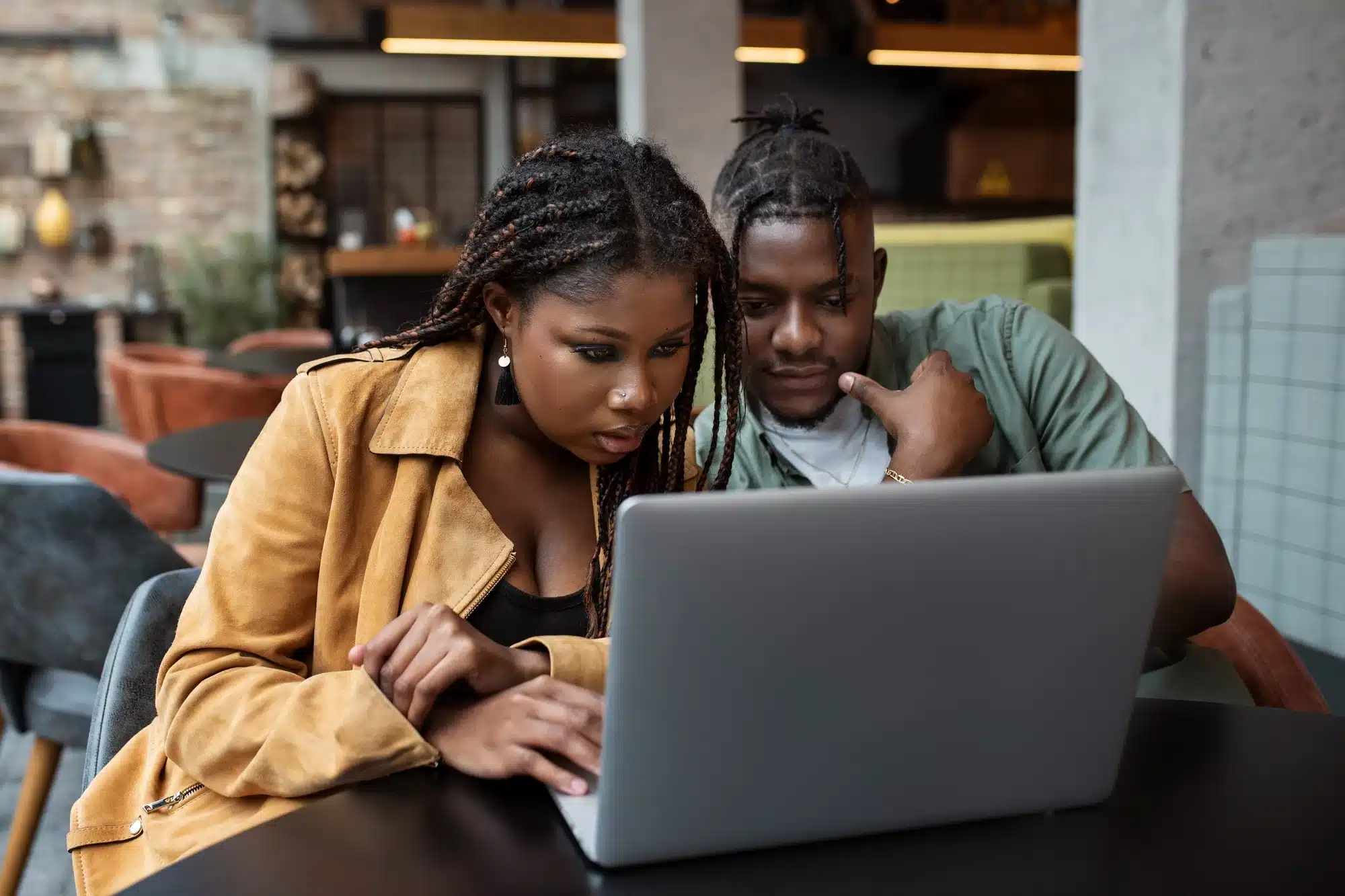 man and woman working on a computer